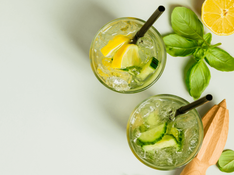 Two glasses of water filled with lime and lemon slices and ice to mix cocktails.