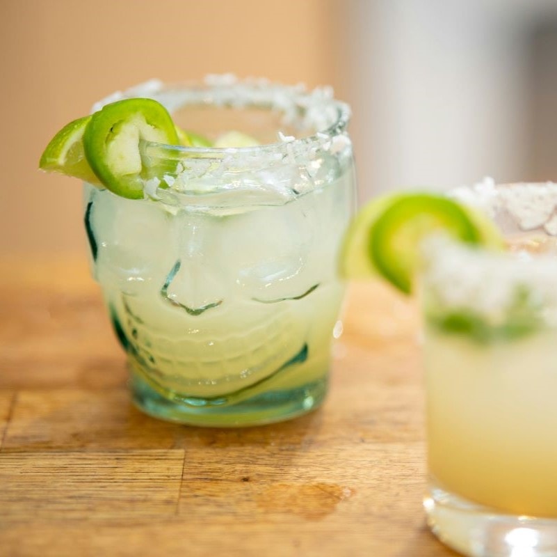 Two Herbal Basil Margaritas with lime slices