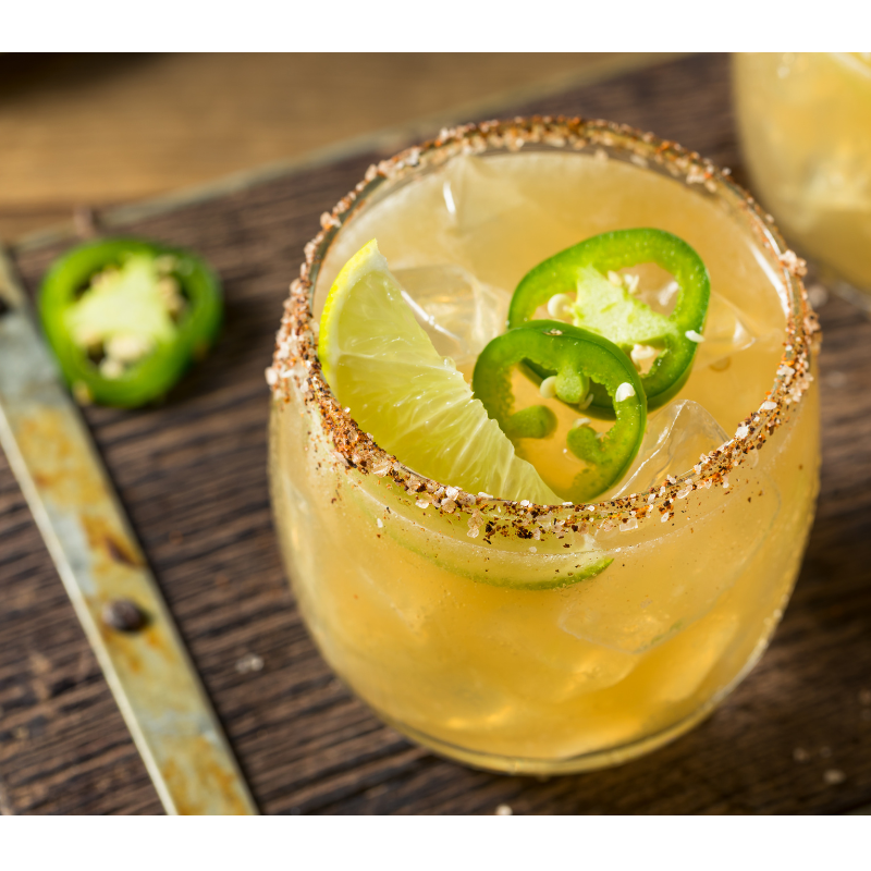 A vibrant margarita made with lime and jalapeños that adds a spicy twist to a classic cocktail.